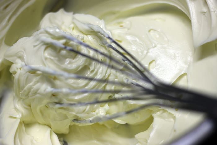 Whisking cream cheese in a mixing bowl