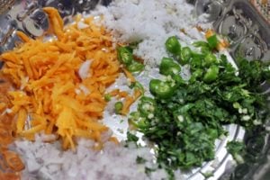 chopped vegetables, grated coconut & chillies in a mixing bowl