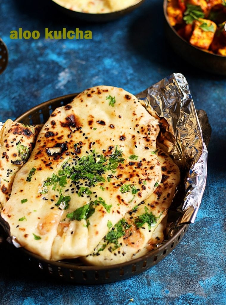 Stuffed aloo kulcha amritsari served in a brass plate