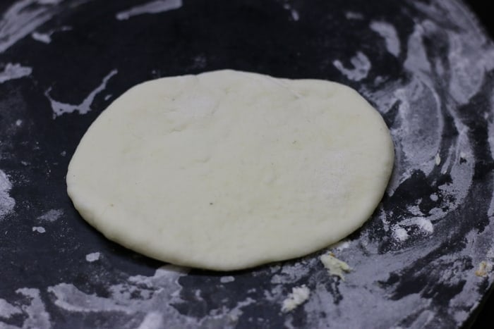 rolling the dough for making kulcha