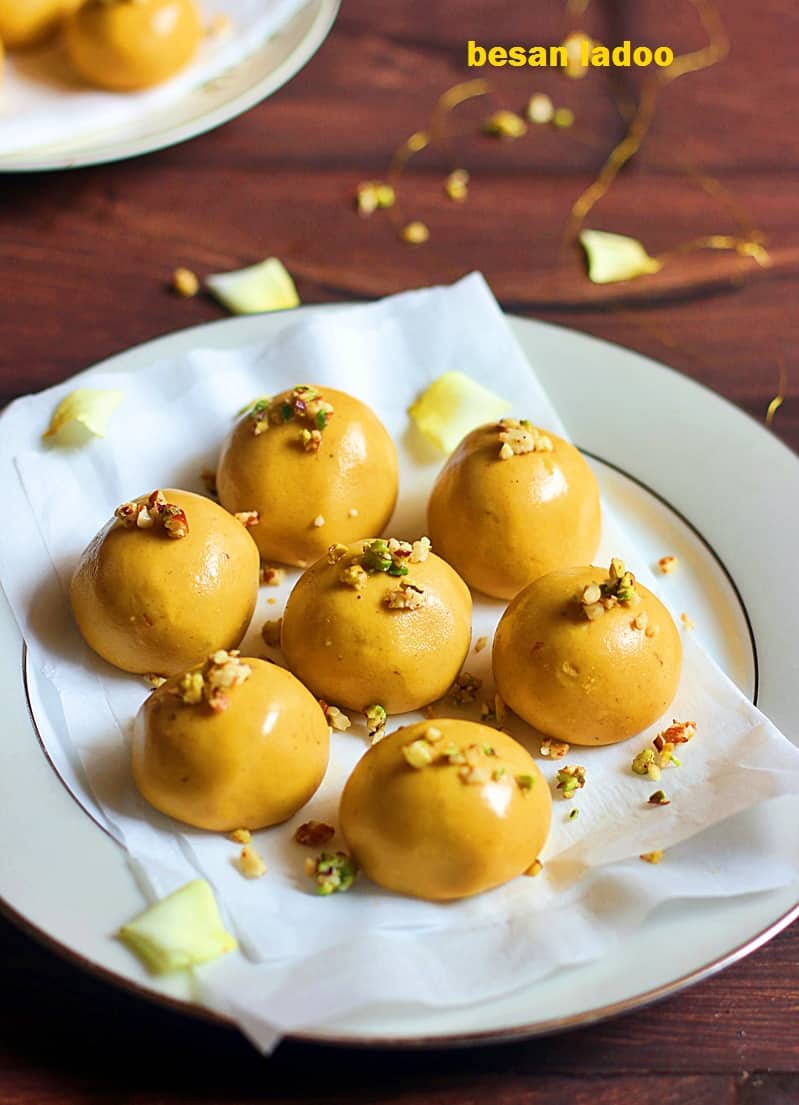 Shiny besan ladoo arranged in a white plate for dessert