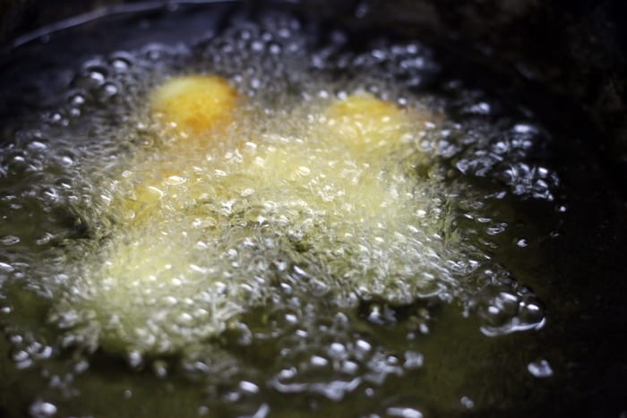 frying khoya gulab jamuns in hot ghee