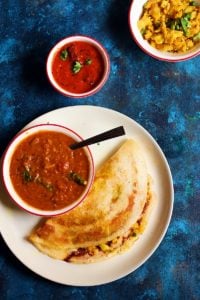 overhead shot masala dosa served with sambar and chutney