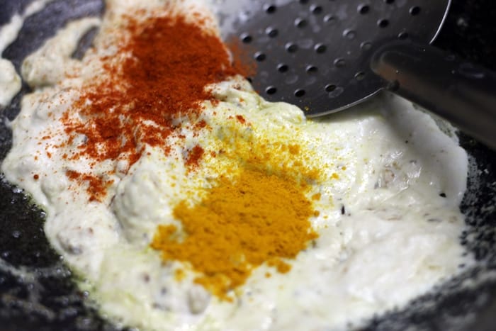 adding turmeric powder, chili powder to sauteed shahi paste.