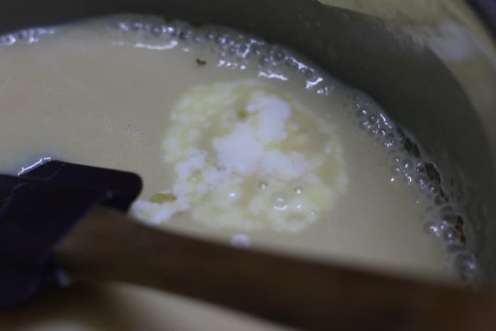 yogurt added to simmering condensed milk for making palkova