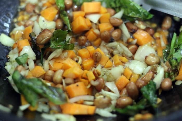 sautéing onions and carrots for making tomato rice