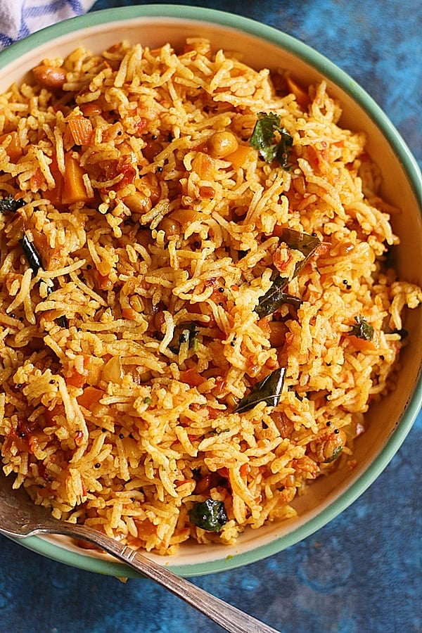 south Indian tomato rice or thakkali sadam from Tamil nadu served in a enamel plate