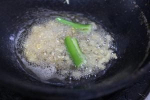 green chili added to the mustard tempering