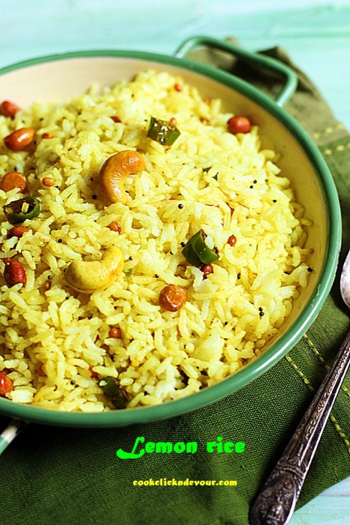 South Indian lemon rice served in green rimmed enamel pan