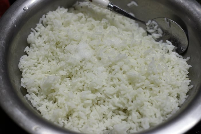 rice tossed with oil and salt for making lemon rice