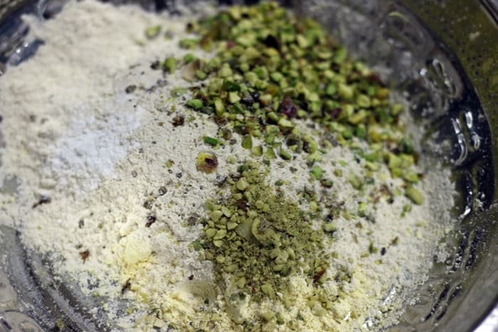 adding dry flours and nuts to creamed ghee and