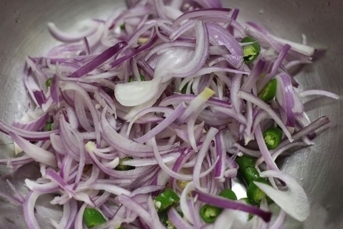 sliced onions and green chilies in a bowl