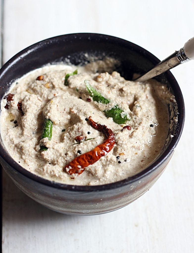 groundnut chutney served in a small bowl with a spoon