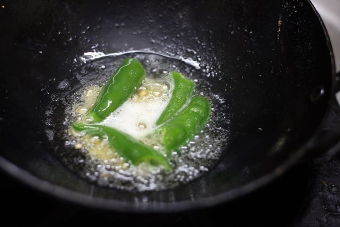Frying chana dal, green chilies and asafoetida for groundnut chutney