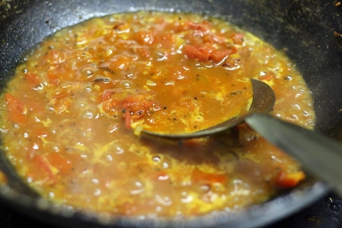 Making traditional delicious tangy tomato chutney recipe
