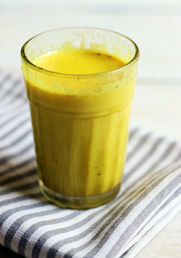 closeup shot of golden milk in a glass