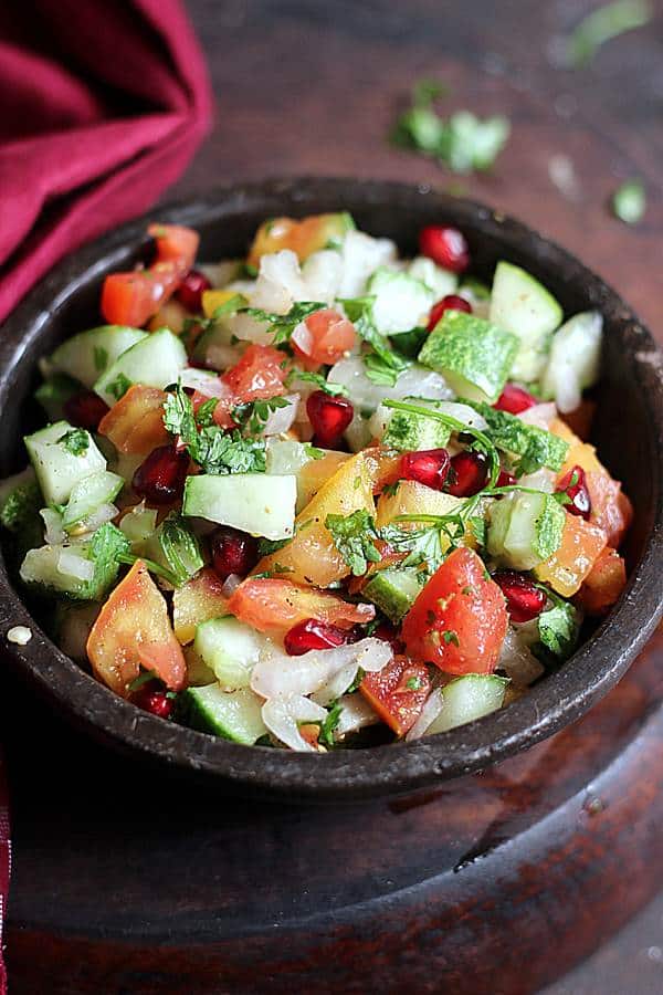 Indian summer salad kachumber served in a stoneware bowl.