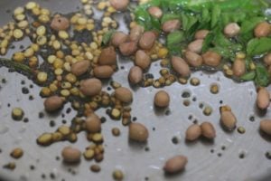 adding curry leaves and peanuts