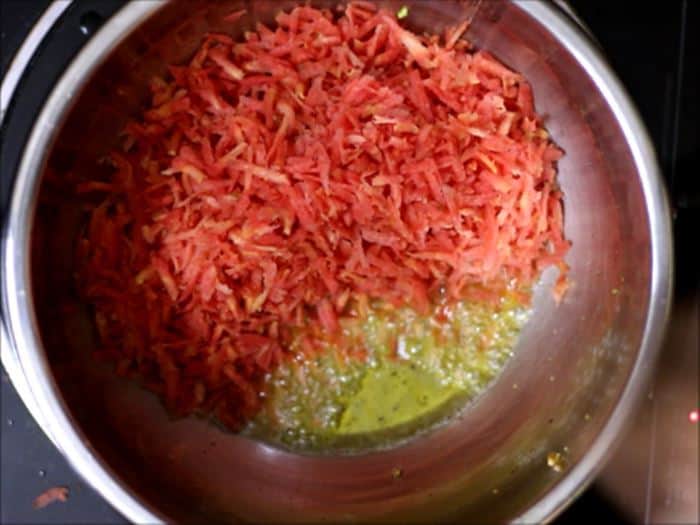 saueting grated carrots in ghee for gajar halwa