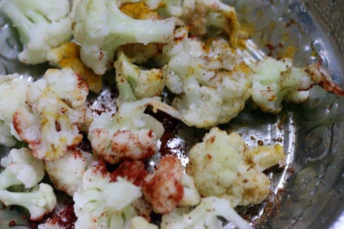 spice powders added to blanched cauliflower florets for gobi fry recipe