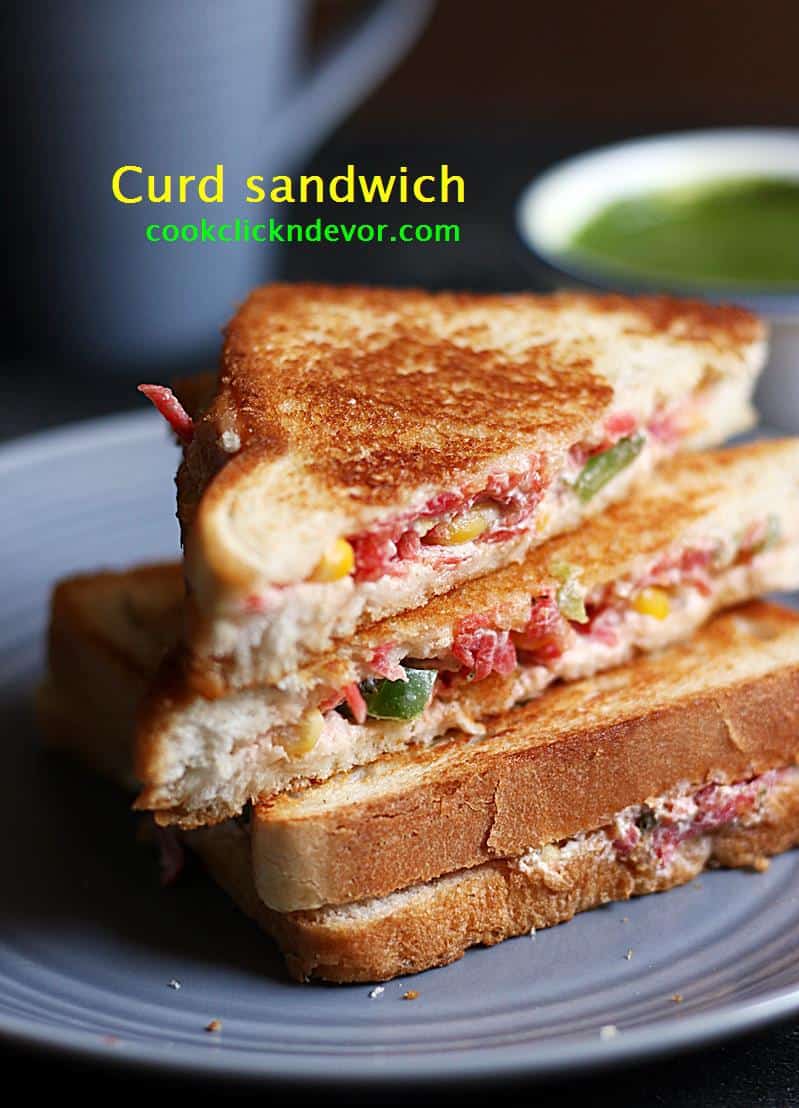 Curd sandwich with vegetables on a plate with some dipping chutney in the background