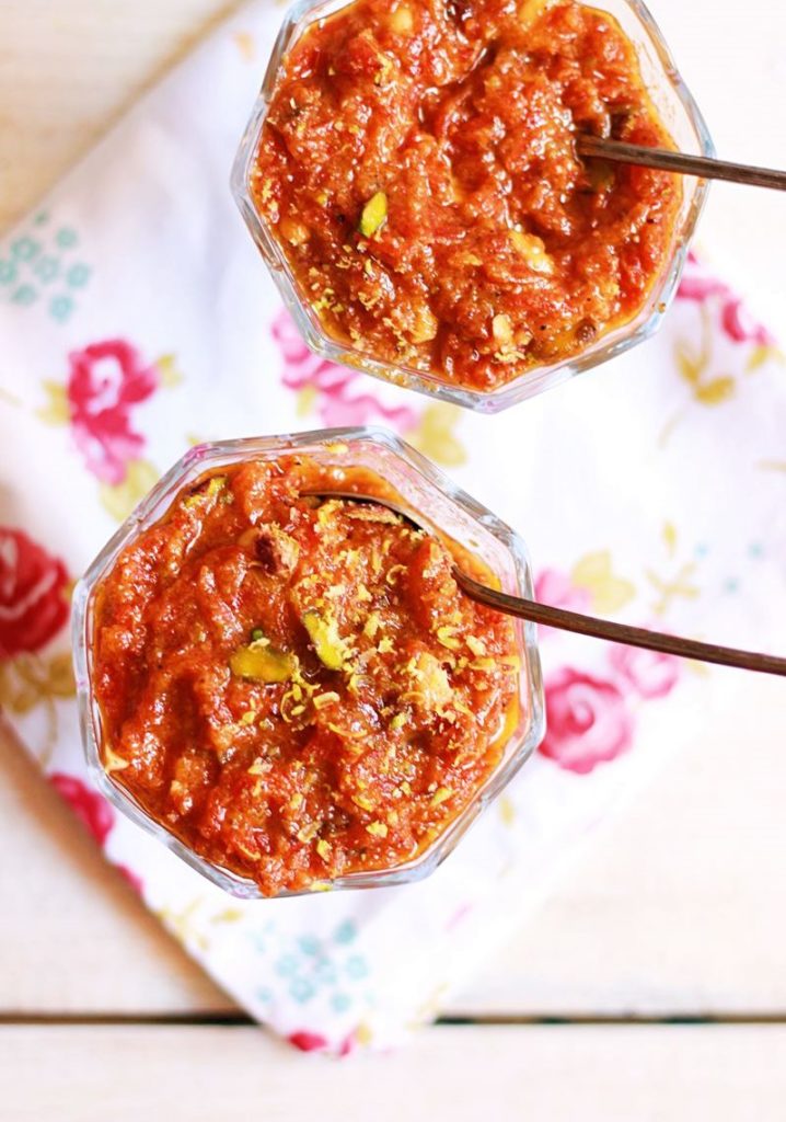 Homemade carrot halwa or gajar halwa served in two dessert bowls with a spoon.