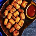 Paneer popcorn recipe- A bown plate with crispy and tasty paneer pops served with sauce.