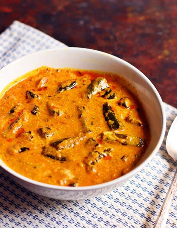 Dahi bhindi recipe- tangy and mildly spiced okra in yogurt curry served for lunch in a white serving bowl.