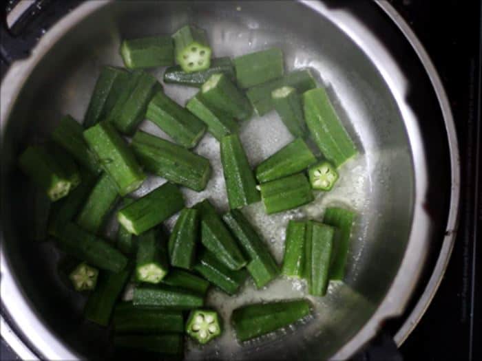 sauteing okra for dahi bhindi recipe, dahi wali bhindi recipe