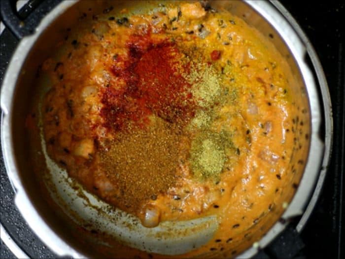 Adding spice powders for dahi bhindi recipe, dahi wali bhindi recipe