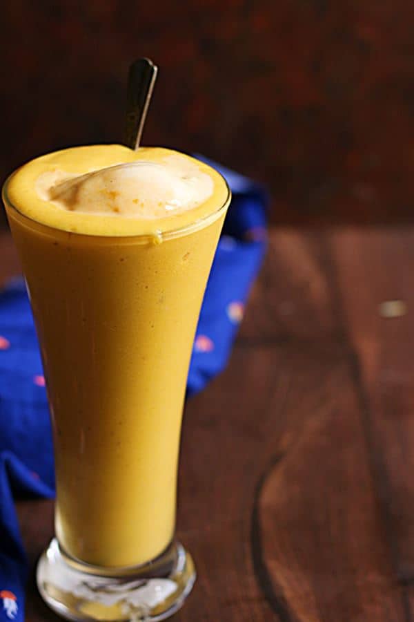 Classic mango milkshake served with a scoop of ice cream and a long spoon