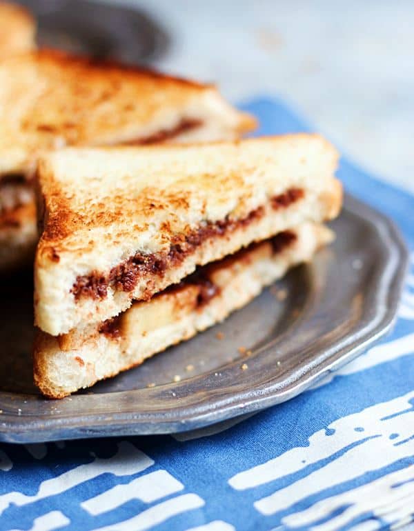 chocolate sandwich with fruit served on a metal plate for breakfast