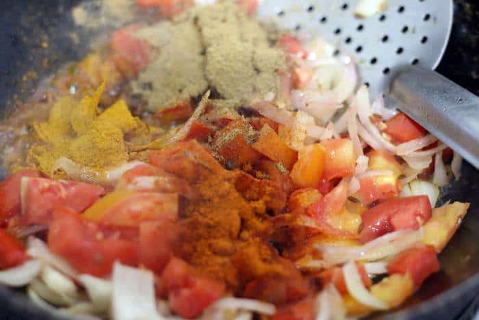 spice powders added to sauteed tomatoes