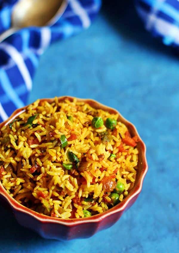 quick and easy masala rice recipe served in a red rice bowl for lunch with a spoon