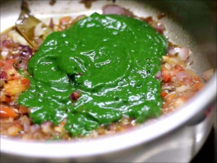 Adding blanched spinach puree or palak puree to sauteed onion tomato masala