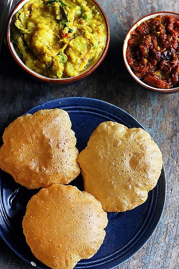 crispy poori served with curries and side dish
