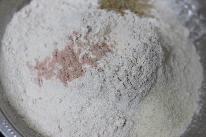 ingredients for puri- whole wheat flour, salt, sugar , semolina in a mixing bowl