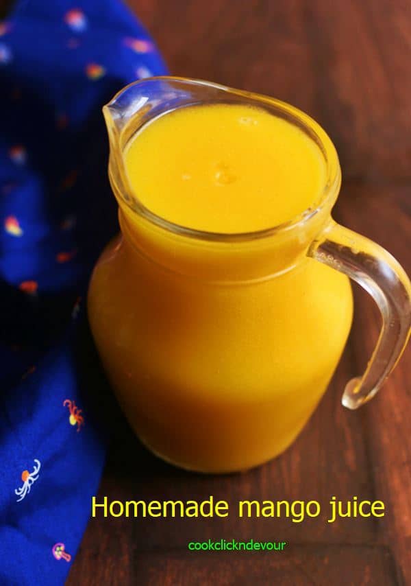 Homemade mango juice recipe with fresh mangoes in a pitcher