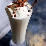 vanilla milkshake recipe- best homemade vanilla milkshake with ice cream,garnished with crushed cookies and chocolate chips.