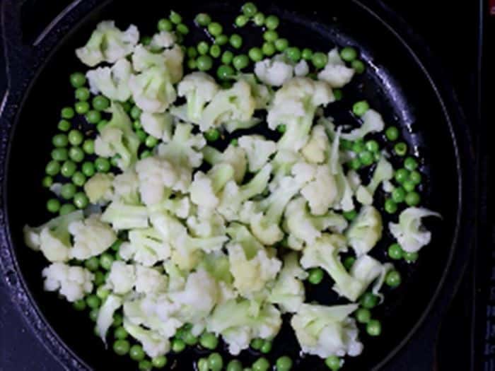 adding blanched cauliflower-making gobi matar recipe