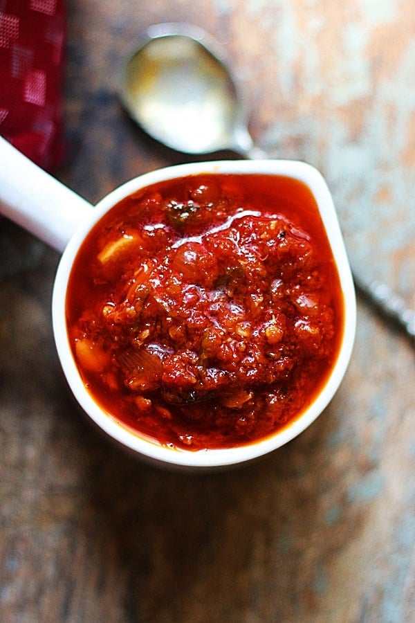 Schezwan sauce served in a while ceramic cup