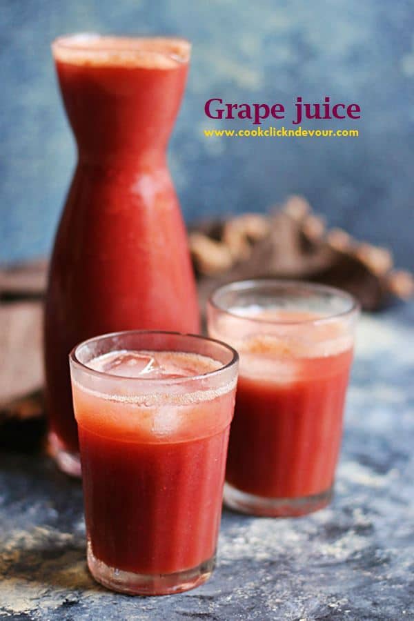 Homemade grape juice served in two glasses with ice cubes. More grape juice in a beaker in the background.