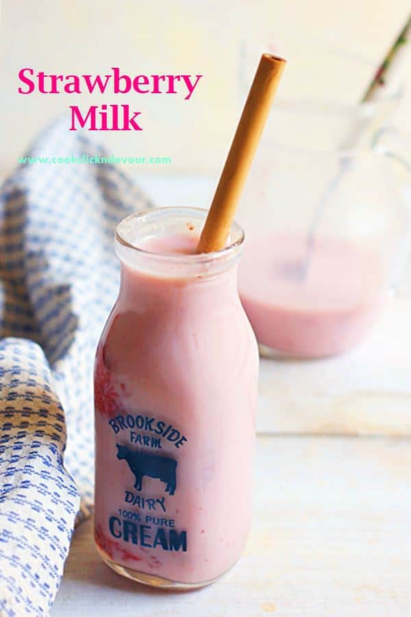 Homemade Strawberry Milk served with a bamboo straw in a small bottle
