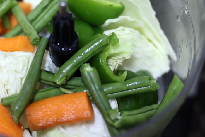 Mixed veggies in a food processor bowl