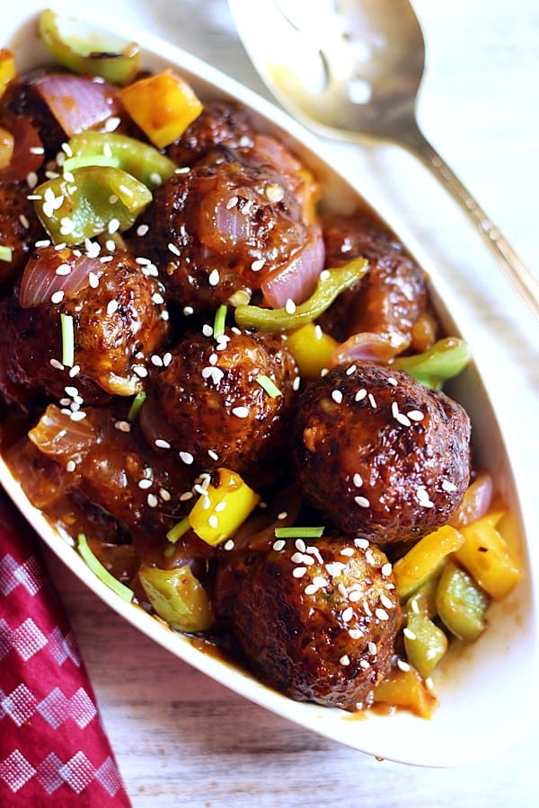 crispy veg manchurian served in a white ceramic bowl with a spoon