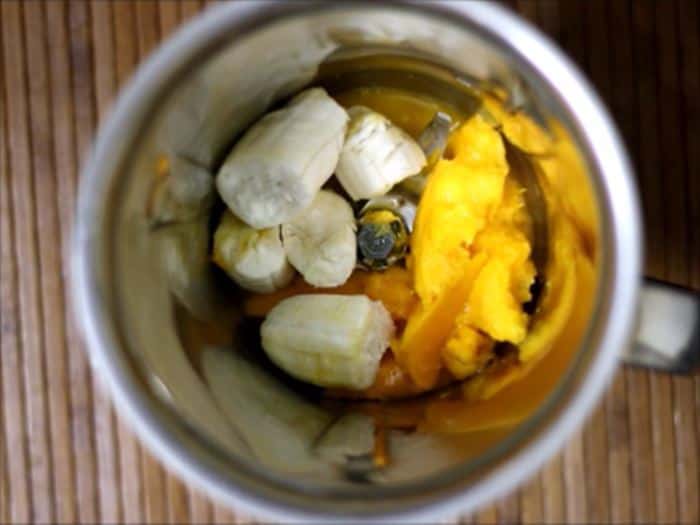 Blending bananas and mangoes for banana mango smoothie recipe