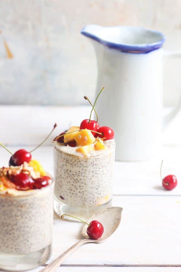 Vanilla chia pudding served in a glass tumbler with fruits and nuts topping