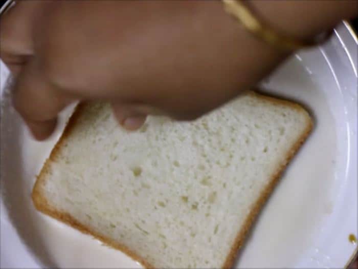 dipping bread slice in sweet milk