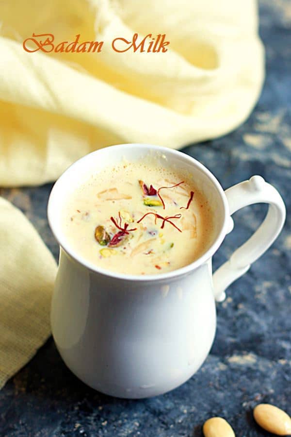 Rich Indian badam milk with saffron, garnished with nuts served in a elegant white cup