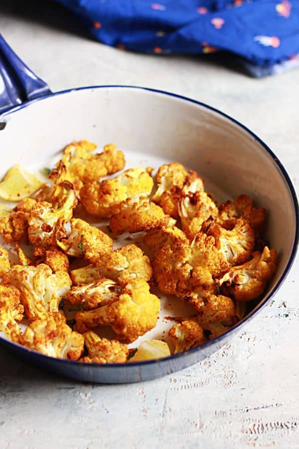 roasted cauliflower served in a enamel bowl